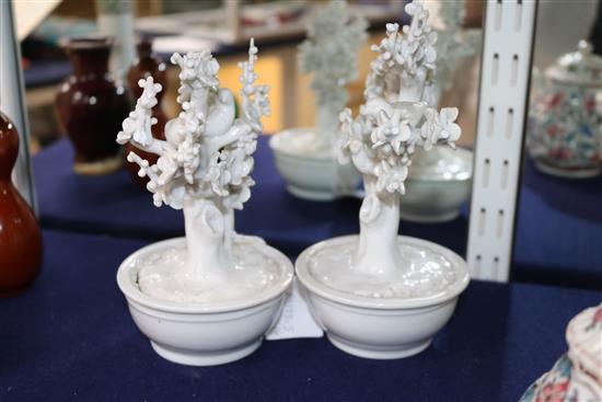 A pair of Chinese blanc de Chine models of birds in prunus trees